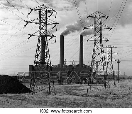 Stock Image - 1950S Industrial Power Plant Billowing Smoke To Generate Electricity Power Line Towers In Foreground . Fotosearch