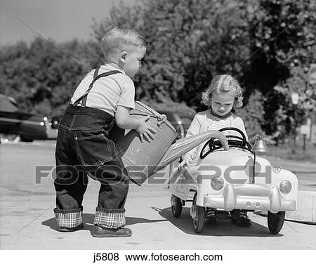 1950S Little Boy Playing Gas Station Pouring Water Into Toy Car For Little Girl View Large Photo Image Stock Photo - 1950S Little Boy Playing Gas Station Pouring Water Into Toy Car For Little Girl . Fotosearch