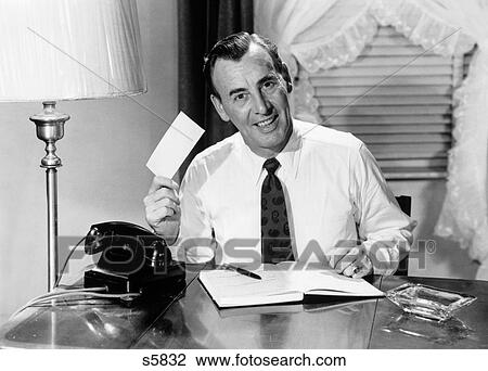 1950S Man At Home Desk Writing Checks Sitting By Telephone Looking At Camera View Large Photo Image Stock Image - 1950S Man At Home Desk Writing Checks Sitting By Telephone Looking At Camera. Fotosearch