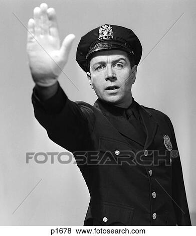 1950S Man Policeman In Uniform Holding Hand Up In Air Towards Camera Stop Halt Warning Looking At Camera View Large Photo Image Stock Photo - 1950S Man Policeman In Uniform Holding Hand Up In Air Towards Camera Stop Halt Warning Looking At Camera. Fotosearch