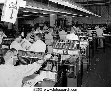 Stock Image - 1950S Men Working In Newspaper Advertisement Composing Room Setting Ad Type . Fotosearch
