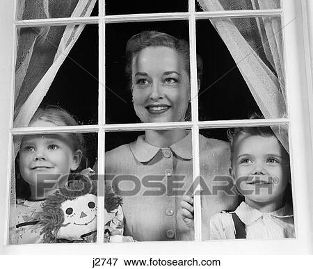 1950S Mom With Two Kids Looking Out Window Towards Viewer View Large Photo Image Stock Photo - 1950S Mom With Two Kids Looking Out Window Towards Viewer. Fotosearch