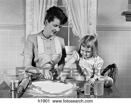1950S Mother & Daughter Baking Together In Kitchen Cutting Dough With Cookie Cutters View Large Photo Image Stock Image - 1950S Mother & Daughter Baking Together In Kitchen Cutting Dough With Cookie Cutters. Fotosearch