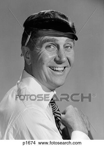 Picture - 1950S Portrait Man Accountant Smiling Wearing Eye Shade Visor With Pencil Behind Ear Looking At Camera. Fotosearch