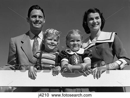 1950S Portrait Smiling Family Father Mother Daughter Son Standing Together Behind White Fence Outdoor View Large Photo Image Stock Image - 1950S Portrait Smiling Family Father Mother Daughter Son Standing Together Behind White Fence Outdoor . Fotosearch