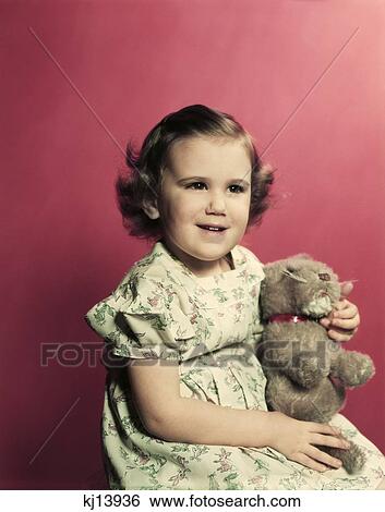 1950S Portrait Smiling Toddler Girl Holding Stuffed Animal Toy View Large Photo Image Stock Photograph - 1950S Portrait Smiling Toddler Girl Holding Stuffed Animal Toy . Fotosearch