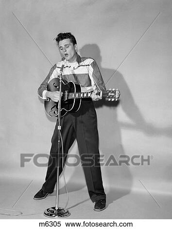 1950S Rockabilly Singer In Front Of Microphone Strumming Hollow-Body Guitar View Large Photo Image Stock Photography - 1950S Rockabilly Singer In Front Of Microphone Strumming Hollow-Body Guitar. Fotosearch