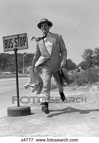 Stock Photo - 1950S Salesman Running To Catch Bus At Bus Stop Sign Outdoor. Fotosearch