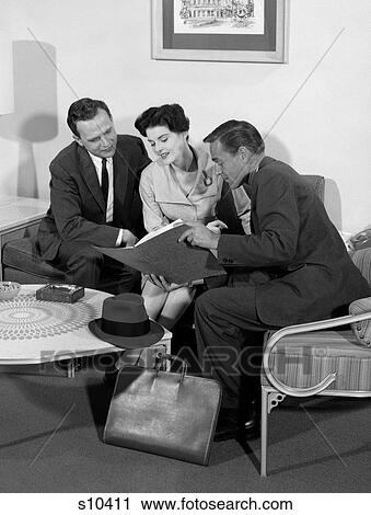 1950S Salesman Showing Folder To Couple At Home In Living Room View Large Photo Image Stock Image - 1950S Salesman Showing Folder To Couple At Home In Living Room. Fotosearch