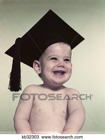 Stock Image - 1950S Smiling Baby Boy Wearing Graduation Cap Mortarboard. Fotosearch