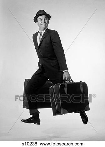 1950S Smiling Man Carrying Two Suitcases Stepping Out Salesman Businessman Looking At Camera View Large Photo Image Stock Photo - 1950S Smiling Man Carrying Two Suitcases Stepping Out Salesman Businessman Looking At Camera. Fotosearch
