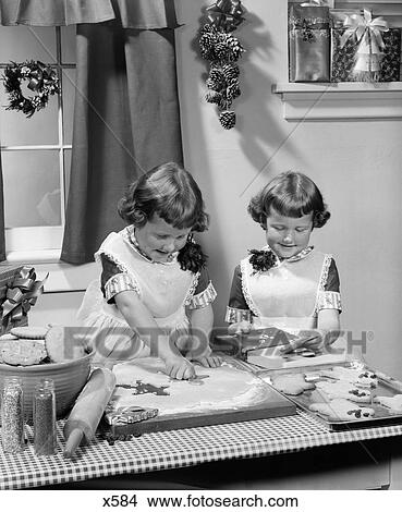 1950S Twin Girls Sisters Baking Christmas Cookies View Large Photo Image Picture - 1950S Twin Girls Sisters Baking Christmas Cookies . Fotosearch