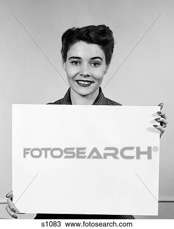 1950S Woman Holding Blank Sign In Front Of Chest Smiling Indoor View Large Photo Image Stock Image - 1950S Woman Holding Blank Sign In Front Of Chest Smiling Indoor. Fotosearch