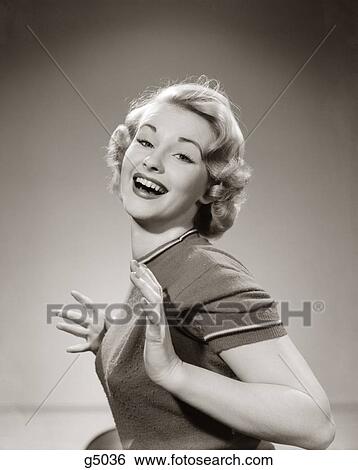 1950S Young Woman Smiling With Both Thumbs Tucked Under Her Arm Looking At Camera View Large Photo Image Stock Photograph - 1950S Young Woman Smiling With Both Thumbs Tucked Under Her Arm Looking At Camera. Fotosearch