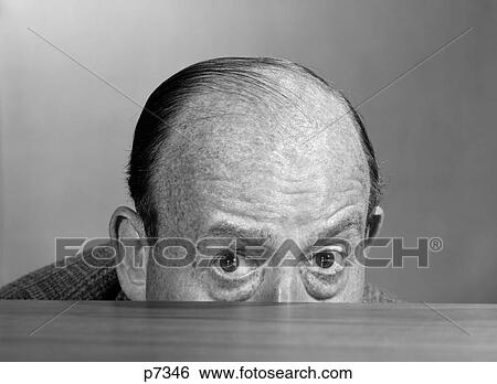 1960S Balding Man Peeking Over Desktop With Only Top Half Of Head Showing Looking At Camera View Large Photo Image Stock Photograph - 1960S Balding Man Peeking Over Desktop With Only Top Half Of Head Showing Looking At Camera. Fotosearch