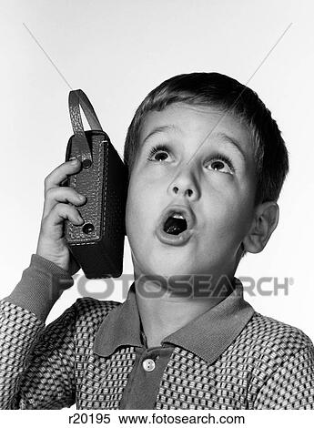 1960S Boy Holding Transistor Radio Up To His Ear While He Sings Along View Large Photo Image Stock Photography - 1960S Boy Holding Transistor Radio Up To His Ear While He Sings Along. Fotosearch