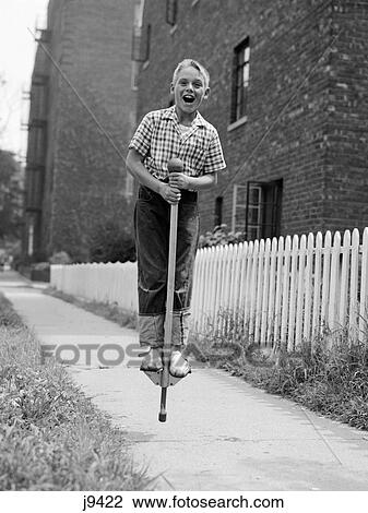 1960S Boy On Pogo Stick On Sidewalk View Large Photo Image Stock Image - 1960S Boy On Pogo Stick On Sidewalk. Fotosearch