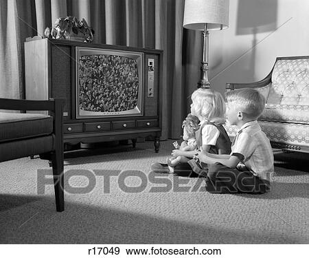 1960S Brother & Sister Sitting On Living Room Floor Watching Tv View Large Photo Image Stock Photo - 1960S Brother & Sister Sitting On Living Room Floor Watching Tv. Fotosearch