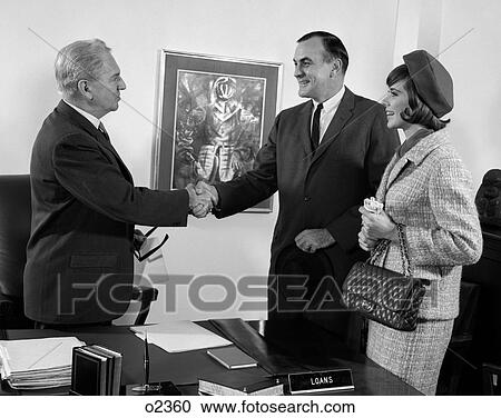 1960S Couple Husband And Wife Shaking Hands With Bank Loan Manager Business Indoor View Large Photo Image Stock Image - 1960S Couple Husband And Wife Shaking Hands With Bank Loan Manager Business Indoor. Fotosearch
