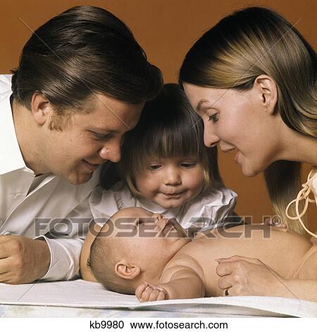 1960S Family Looking At New Baby Mother Father Sister View Large Photo Image Stock Image - 1960S Family Looking At New Baby Mother Father Sister. Fotosearch