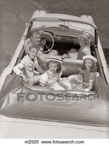 1960S Family Portrait Father Mother Son Two Daughters In Convertible Car Outdoor Looking Up At Camera View Large Photo Image Stock Photography - 1960S Family Portrait Father Mother Son Two Daughters In Convertible Car Outdoor Looking Up At Camera. Fotosearch