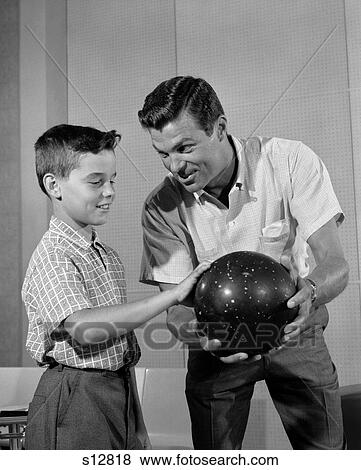 Stock Photo - 1960S Father Showing Son How To Hold Bowling Ball Indoor. Fotosearch