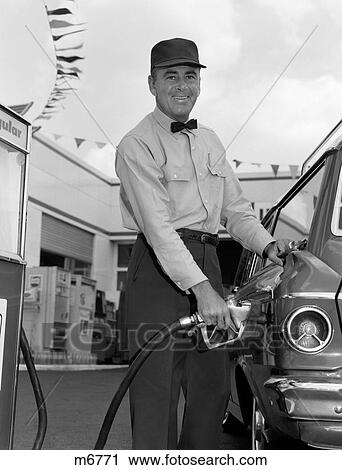 1960S Male Service Station Attendant Wearing Cap And Bow Tie Smiling While Pumping Gasoline Outside View Large Photo Image Stock Image - 1960S Male Service Station Attendant Wearing Cap And Bow Tie Smiling While Pumping Gasoline Outside. Fotosearch
