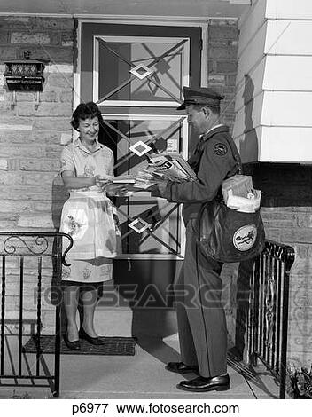 Stock Photo - 1960S Man Mailman Delivering Mail To Woman Housewife In Front Of Suburban House Outdoor. Fotosearch