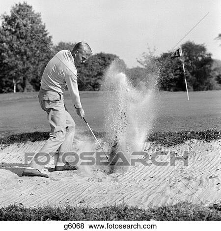 1960S Man Playing Golf Chipping Golf Ball Out Of A Sand Trap View Large Photo Image Stock Photo - 1960S Man Playing Golf Chipping Golf Ball Out Of A Sand Trap. Fotosearch