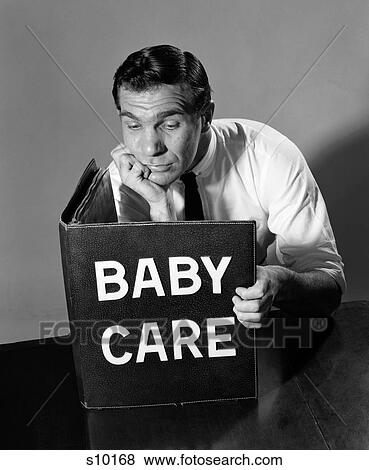 1960S Man Prospective Father Reading Large Book Titled Baby Care With Bemused Expression View Large Photo Image Stock Photo - 1960S Man Prospective Father Reading Large Book Titled Baby Care With Bemused Expression. Fotosearch
