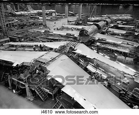 Stock Image - 1960S Overhead View Of Jet Airplane Assembly Line With Several Pairs Of Wing. Fotosearch