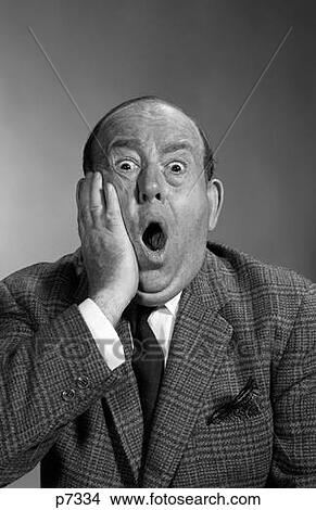 Picture - 1960S Portrait Of Balding Man Holding Hand Up To Face With Shocked Expression Eyes Bulging Looking At Camera & Mouth Open. Fotosearch
