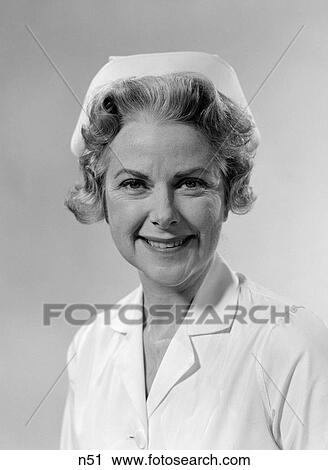 1960S Portrait Of Woman Nurse Smiling Wearing White Cap And Uniform Studio Indoor View Large Photo Image Stock Image - 1960S Portrait Of Woman Nurse Smiling Wearing White Cap And Uniform Studio Indoor. Fotosearch