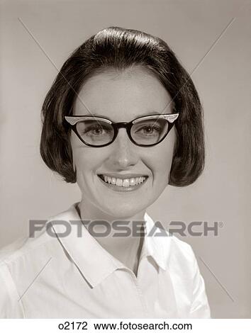 Stock Image - 1960S Smiling Portrait Woman Wearing Horn-Rimmed Glasses Looking At Camera. Fotosearch