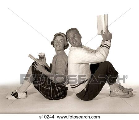 Picture - 1960S Teen Male & Female Back To Back Looking Towards Each Other Studying. Fotosearch