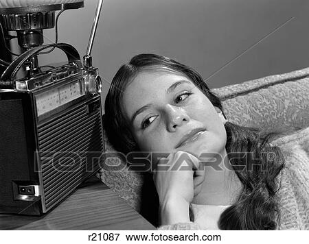 1960S Teenage Girl Listening To Portable Radio Wistful Expression Indoor View Large Photo Image Stock Photo - 1960S Teenage Girl Listening To Portable Radio Wistful Expression Indoor. Fotosearch