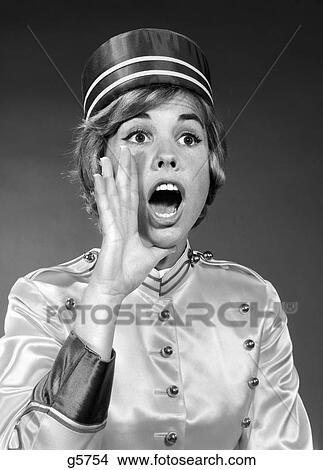 Picture - 1960S Woman In Bell Hop Outfit Yelling An Announcement . Fotosearch