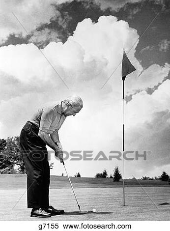 1970S Man Playing Golf Putting Golf Ball On Green To Flag And Cup Outdoor View Large Photo Image Stock Photography - 1970S Man Playing Golf Putting Golf Ball On Green To Flag And Cup Outdoor. Fotosearch