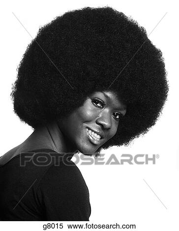 1970S Portrait Of Smiling African American Woman With Large Afro Hair Style Leaning Forward Looking At Camera Over Shoulder View Large Photo Image Stock Photography - 1970S Portrait Of Smiling African American Woman With Large Afro Hair Style Leaning Forward Looking At Camera Over Shoulder. Fotosearch