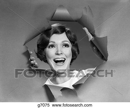 1970S Portrait Of Smiling Woman Looking Through A Hole Torn In Paper View Large Photo Image Stock Photography - 1970S Portrait Of Smiling Woman Looking Through A Hole Torn In Paper. Fotosearch