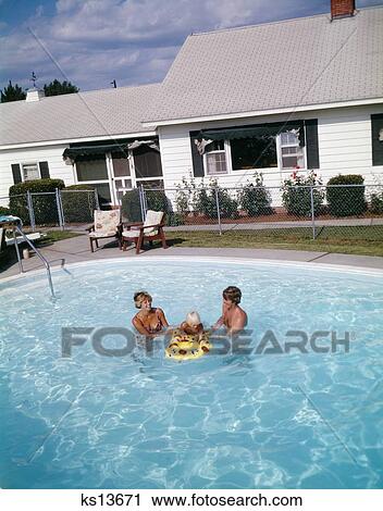 1980 1980S Retro Family Mom Dad Baby Backyard Swimming View Large Photo Image Stock Image - 1980 1980S Retro Family Mom Dad Baby Backyard Swimming . Fotosearch
