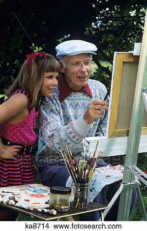 1980S 1990S Granddaughter Watching Grandfather Paint At Easel View Large Photo Image Picture - 1980S 1990S Granddaughter Watching Grandfather Paint At Easel. Fotosearch