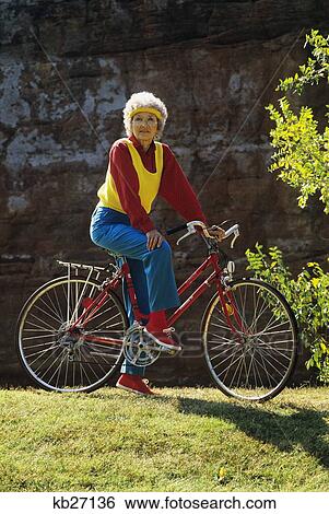 1980S Senior Woman On Bicycle Standing Still Looking At Camera View Large Photo Image Stock Photograph - 1980S Senior Woman On Bicycle Standing Still Looking At Camera. Fotosearch