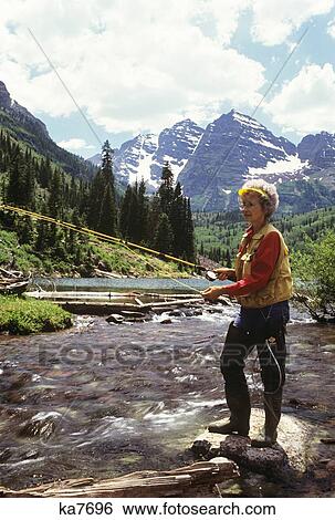 1990S Mature Woman Fly Fishing Mountain Stream View Large Photo Image Stock Photograph - 1990S Mature Woman Fly Fishing Mountain Stream . Fotosearch