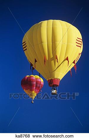 1990S Red And Yellow Hot Air Balloons In Blue Cloudless Sky View Large Photo Image Stock Photo - 1990S Red And Yellow Hot Air Balloons In Blue Cloudless Sky. Fotosearch