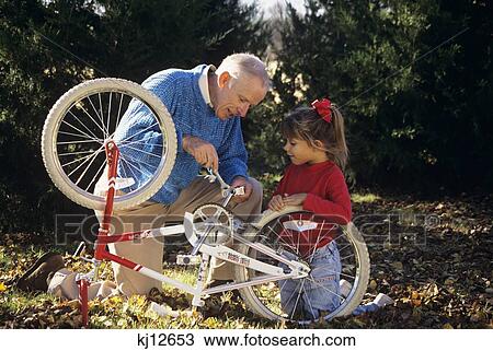 Grandfather Fixing Bicycle For Granddaughter View Large Photo Image Stock Image - Grandfather Fixing Bicycle For Granddaughter . Fotosearch