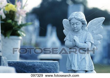 Stock Photo - Praying Angel Statue On Grave Cemetery New Orleans Louisiana . Fotosearch
