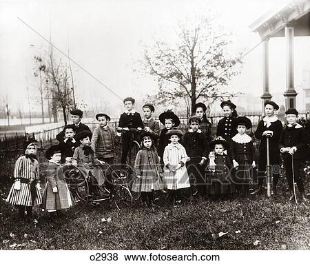 1890S 1900S Posed Group Portrait Of 18 Turn Of The 20Th Century Neighborhood Children Assembled In Suburban Front Yard View Large Photo Image Stock Photo - 1890S 1900S Posed Group Portrait Of 18 Turn Of The 20Th Century Neighborhood Children Assembled In Suburban Front Yard. Fotosearch