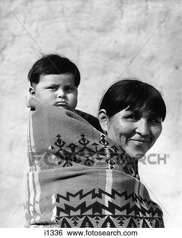 1930S Smiling Pueblo Mother & Child On Back Both Wrapped In Woven Blanket Papoose View Large Photo Image Stock Photograph - 1930S Smiling Pueblo Mother & Child On Back Both Wrapped In Woven Blanket Papoose. Fotosearch