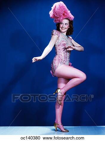 1940S 1950S Smiling Woman Showgirl Dancer Performer Wearing Pink Burlesque Costume With Feather Headpiece View Large Photo Image Stock Image - 1940S 1950S Smiling Woman Showgirl Dancer Performer Wearing Pink Burlesque Costume With Feather Headpiece. Fotosearch